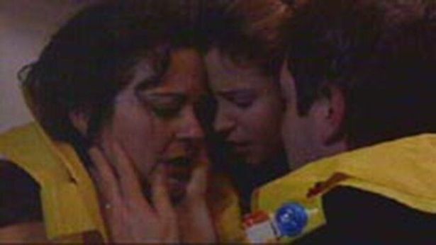 Screenshot of Liljana, Serena and David Bishop wearing lifejackets, embracing each other as their plane goes down.