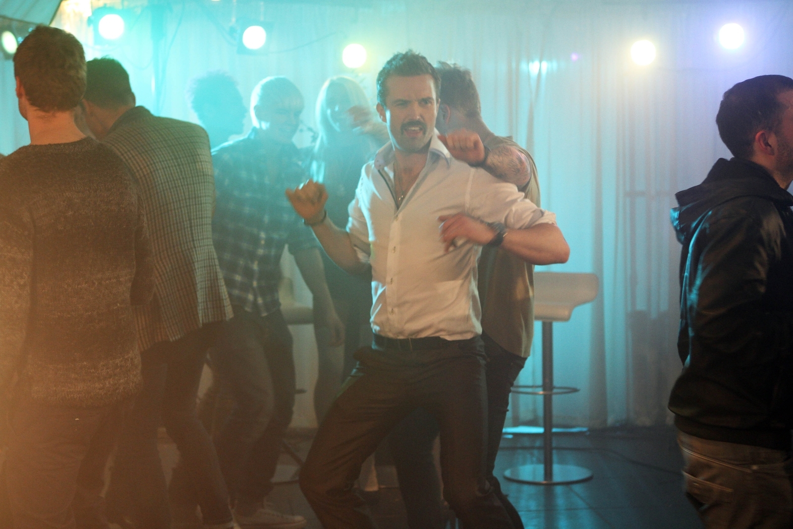 Brendan dances awkwardly in a busy night club.