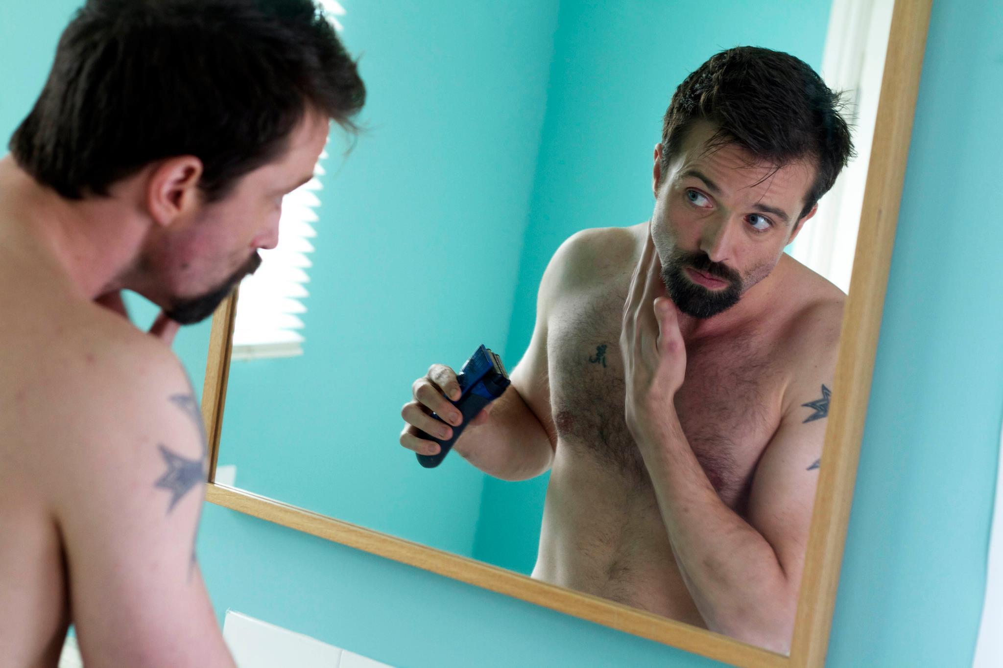 Brendan begins to restore his signature moustache by shaving his prison beard in the mirror.