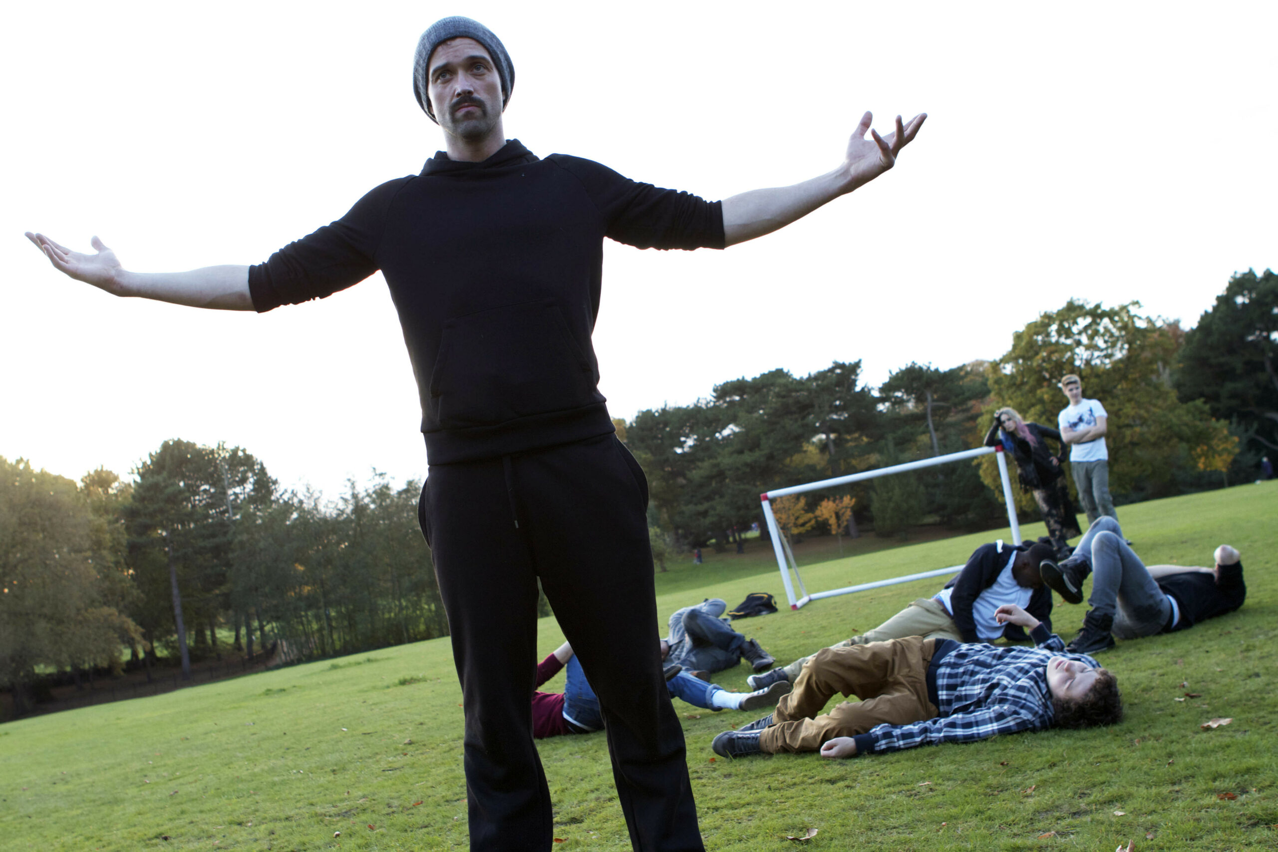 Brendan shows off to his son that he took down the other players in a football match.