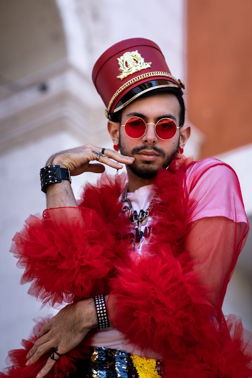 man in pink t shirt and red boa