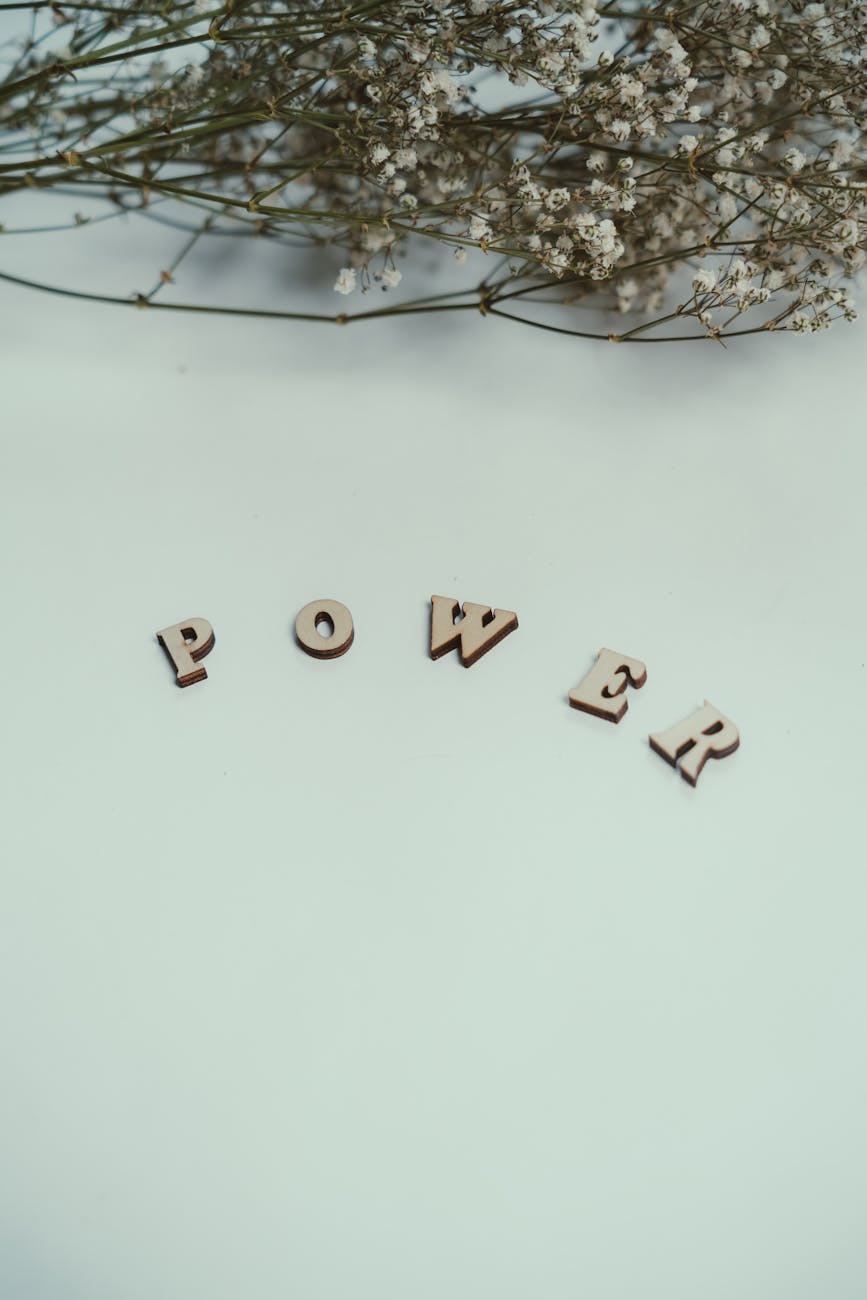 wooden letters spell power with floral accent